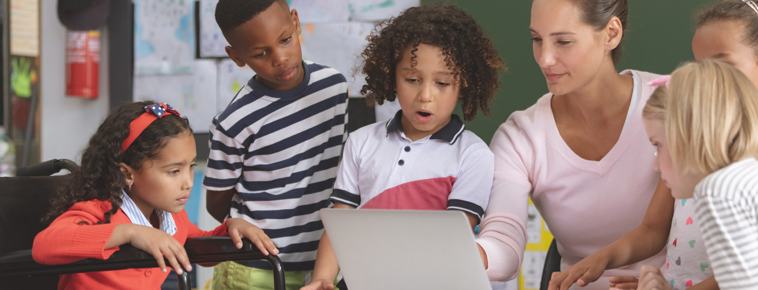 Teacher helping her students in class.